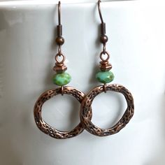 "Copper and Turquoise Hoop Earrings - Textured Antiqued Copper plated Pewter Hoops dangle from Czech Faceted Glass Turquoise Rondelle Beads with a Picasso finish and Small Copper Beads. Hoops are just over .75\" in diameter (size of US nickel) Antiqued Copper Earwires Earrings measure 2\" from top of earwires to bottom hoops." Green Metal Hoop Earrings As A Gift, Copper Hoop Earrings For Gift, Green Circular Hoop Earrings As A Gift, Green Circular Hoop Earrings For Gifts, Green Circle Hoop Earrings As Gift, Green Circle Hoop Earrings For Gift, Handmade Copper Round Hoop Earrings, Handmade Green Metal Hoop Earrings, Copper Dangle Hoop Earrings Gift