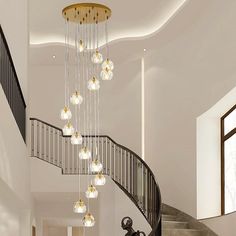 an elegant staircase with chandelier and glass balls hanging from it's handrail