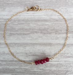 Ruby Bar Bracelet. This beautiful ruby bar bracelet features 5 faceted rubies wire wrapped onto a gold-filled chain. The rubies are approximately 2-3 mm. Ruby is the birthstone of July. Your bracelet will arrive in a gift box. If this is a gift, I would be happy to include a card with your personal message - just let me know in the message section at checkout. Ruby Bracelet Gold, Bracelet Minimal, Bracelet Layering, Minimal Bracelet, Ruby Bracelet, Bar Bracelet, Dainty Bracelet, Myrtle Beach Sc, Bar Bracelets