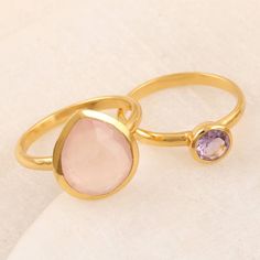 Designed with pink and purple jewels, Neetu Barathi's feminine pair of stacking rings look great together or apart. Indian artisans use 18k gold-plated sterling silver to hand craft the pair, centering one with faceted amethyst, the other with faceted rose quartz. Pink Amethyst Ring With Gemstone Accents As Gift, Pink Stackable Rings With Ethical Gemstones As Gift, Gold Stackable Rings With Gemstone Accents For Gift, Gold Stackable Rings With Gemstone Accents As A Gift, Adjustable Pink Gemstone Stackable Rings, Gemstone Stacking Ring, Hand Craft, Handmade Gold, Pink And Purple