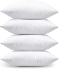 three white pillows stacked on top of each other