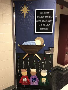 a door decorated to look like a baby jesus in the manger, with congratulations written on it