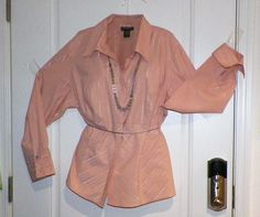 "Vintage Pink/Peach and Silver Ladies Button Down French Cuff Collared Fitted Dress Shirt Size 18 20 Business Blouse and flashy party wear  Designed specifically for both men and women, fitted dress shirts are those shirts that are intended to be slim fitting regardless of the physique of the person wearing them.  Full-figured ladies or men's shirts, for example, are designed to skim over bulges to flatter larger body types. Fitted shirts tend to show off the figure or the build of the person we Business Blouse, Fitted Shirts, French Cuff, Peplum Styles, Fitted Dress Shirts, Pink Peach, Men's Shirts, Full Figured, Dress Shirts