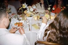 a group of people sitting around a dinner table