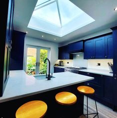 The Korniche Roof Lantern fills a blue kitchen will light. Bespoke Design