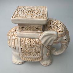 an elephant figurine with ornate carvings on it's trunk and back legs