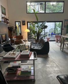 a living room filled with furniture and lots of windows