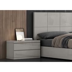 a bedroom with a bed, night stand and nightstand in grey color on the floor