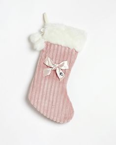 a pink christmas stocking with a bow on it