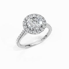 a white gold ring with an oval cut diamond surrounded by pave set round brilliant diamonds