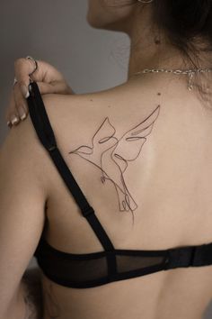 a woman with a bird tattoo on her back