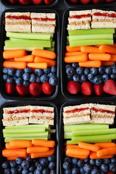 several trays filled with different types of fruit and veggies in each container