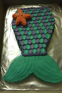 a cake shaped like a mermaid tail with a starfish on it's side