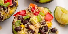 stuffed avocados filled with black beans, rice and veggies on a white plate