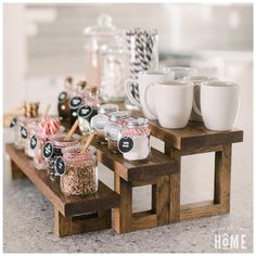 a table topped with lots of jars and cups