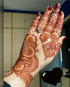 a woman's hand with henna on it