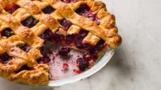 a pie sitting on top of a white table next to a slice missing from it