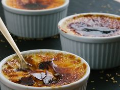 three small bowls filled with food on top of a black tablecloth covered in confetti