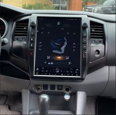 the interior of a car with an electronic display on it's dash board and steering wheel