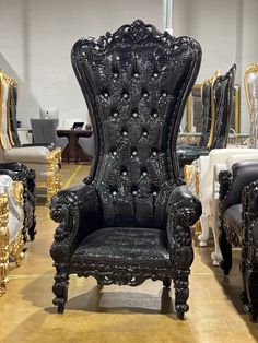 an ornate black chair sits in front of other chairs