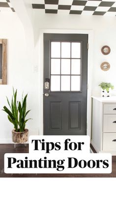 a black door with the words tips for painting doors on it and a potted plant in front