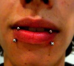 a woman with two piercings on her nose