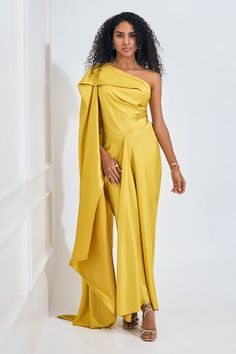 Electric yellow asymmetric dress featuring drape detailing with a flare trail on one side. - Aza Fashions Yellow Draped Fitted Dress, Yellow Fitted Draped Dress, Formal Yellow One-shoulder Dress, Yellow Fitted Pre-draped Dress, Elegant Yellow Asymmetrical Maxi Dress, Yellow Draped Cocktail Dress, Elegant Yellow Dress With Asymmetrical Neckline, Elegant Yellow One-shoulder Dress, Yellow Asymmetrical Maxi Dress For Party