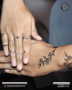 two people with matching tattoos on their arms and hands, one holding the other's hand