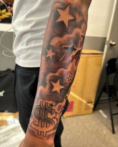 a man with a star and dollar tattoo on his arm