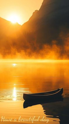 a boat floating on top of a lake next to a mountain range at sunset with the words have a beautiful day