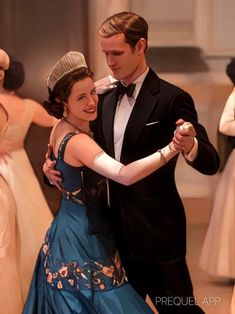 a man and woman in formal dress dancing