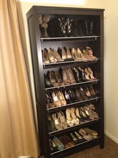 the shoe rack is filled with many pairs of shoes