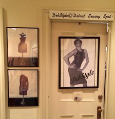 the front door is decorated with mannequins and framed pictures for sale on display