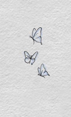 three butterflies flying in the air on a white surface with watercolor paint and black ink