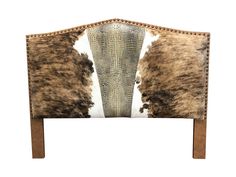 an animal print upholstered headboard with wooden legs and studded trims