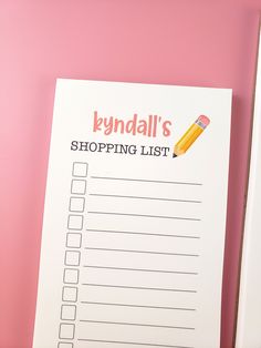 a printable shopping list with a pencil on it next to a pair of scissors