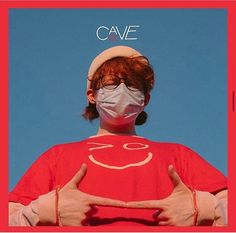 a person wearing a face mask and holding their hands in front of them with the words cave on it