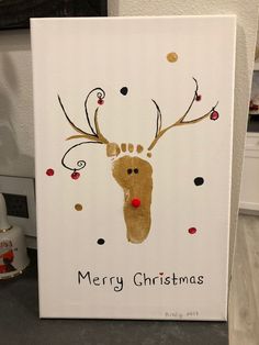 a christmas card with a reindeer's handprint on it