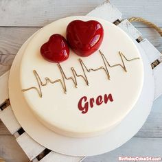 a cake with two hearts on it and the words happy birthday my heart written in red