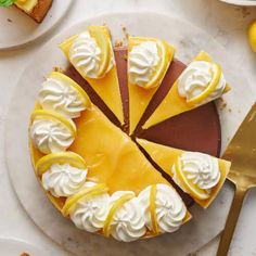 a cheesecake with lemons and whipped cream on top