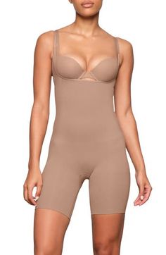 Designed to shape your waist and accentuate your butt, this bodysuit provides targeted compression for a sleek look under outfits. The core and waist areas feature medium compression, while the thigh area offers strong, double-ply compression. The open-bust silhouette allows you to wear your own bra, and the rear offers light support for a lifted, enhanced look. Open bust Adjustable straps Open gusset, open gusset 79% nylon, 21% spandex Machine wash, tumble dry Imported Fitted Push-up Shapewear Bodysuit, Fitted Push-up Bodysuit In Shapewear Style, Elegant Fitted Seamless Shapewear, Fitted Underbust Bodysuit, Solid Bodycon Shapewear, Thigh Wrap Around Tattoo, Shape Your Waist, Wrap Around Tattoo, Thigh Wrap