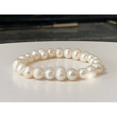 "This classically beautiful and elegant natural freshwater pearl bracelet features natural (Cultured) white freshwater pearls all strung together on high-quality elastic stretch cord. Pearl beads range in 7mm-8mm size.   Freshwater pearls are very versatile and give a polished look to any style of design. Enjoy this perfect addition to your wardrobe.    BRACELET SIZE INSTRUCTIONS  See 2nd Item Photo for a Pictorial Instruction. We make all our bracelets to actual \"wrist size\" (not \"bracelet size\" or \"bracelet length\") Select your actual Wrist Size (in inches) from the dropdown menu.    Simply measure around your wrist in inches at the location where you want to wear the bracelet.     **How to Measure Your Wrist for Proper Bracelet Size**     Wrap a flexible measuring tape around the Fresh Water Pearl Bracelet, Freshwater Pearl Bracelet, Fresh Water Pearl, White Freshwater Pearl, June Birthstone, Freshwater Cultured Pearls, Measuring Tape, June Birth Stone, Gemstone Healing