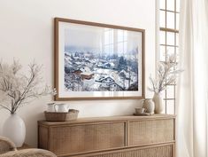 a living room scene with focus on the dresser and framed photograph over it's top