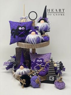 purple and black halloween decorations are stacked on top of each other