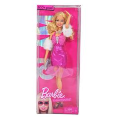 barbie doll in pink dress with sunglasses and fur trimmings on her head, holding a handbag