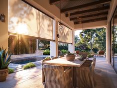 an outdoor dining area with table and chairs