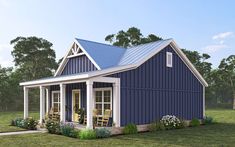 a small blue house sitting on top of a lush green field