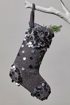 a christmas stocking hanging from a tree branch