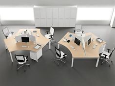 an office cubicle with multiple desks and chairs, all in white and light wood