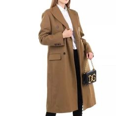 This Angora and Wool Coat by Dolce & Gabbana is a size IT 40 / XS and features a Silk Blend Lined interior. -This luxurious coat is made with a premium blend of angora and wool. -The silk lining adds a touch of elegance to this already stylish piece. -With a size IT 40 / XS, it offers a perfect fit for those looking for a high-quality coat. Designer Wool Coat For Work, Luxury Double-breasted Wool Coat, Brown Tailored Luxury Wool Coat, Luxury Tailored Brown Wool Coat, Designer Wool Coat For Formal Fall Occasions, Luxury Long Sleeve Wool Coat, Designer Long Wool Coat, Elegant Fitted Brown Wool Coat, Designer Fitted Wool Coat